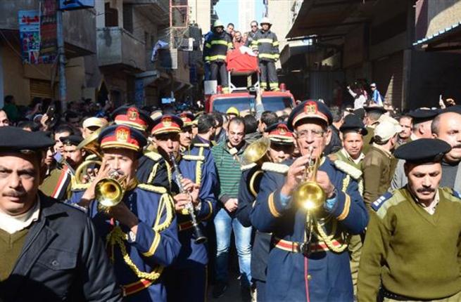 Egyptian men and army officials march during the funeral of an army colonel who was killed in a roadside bombing claimed by the Daesh group on the outskirts of Arish North Sinai