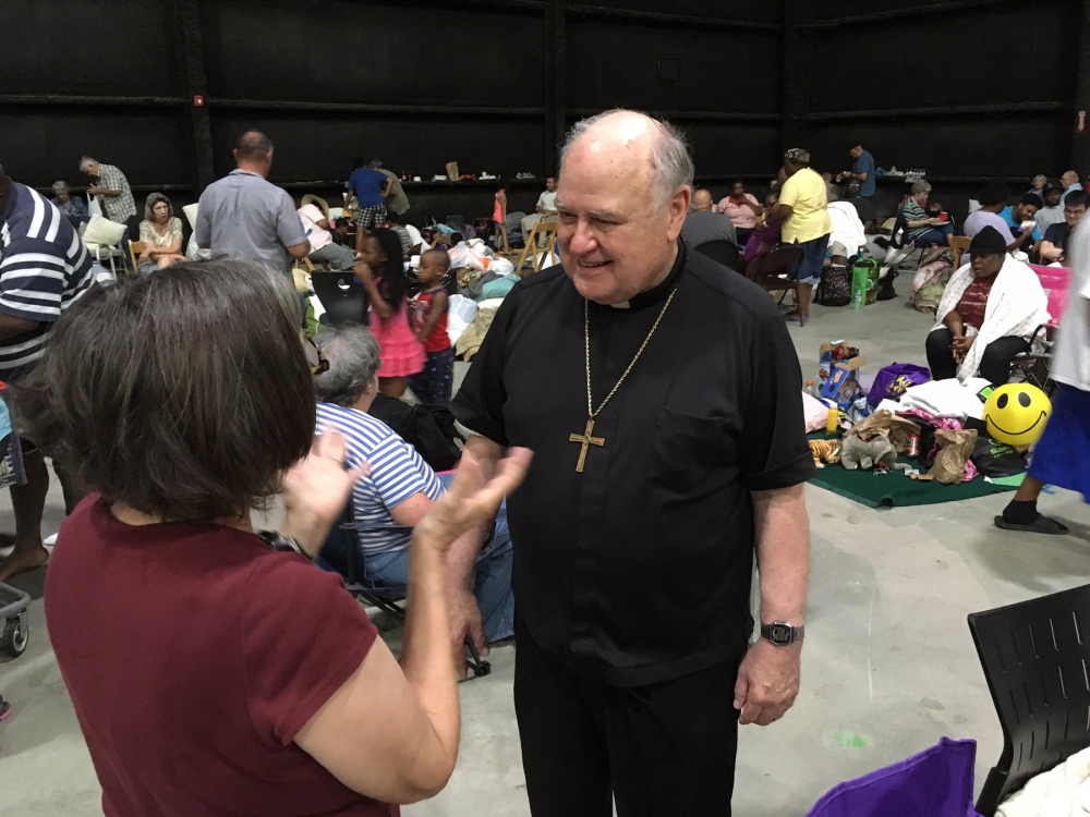 Bishop Robert W. Muench of Baton Rouge La. visited an evacuation shelter Aug. 14. Thousands of people in the Diocese of Baton Rouge have been displaced because of extreme flooding