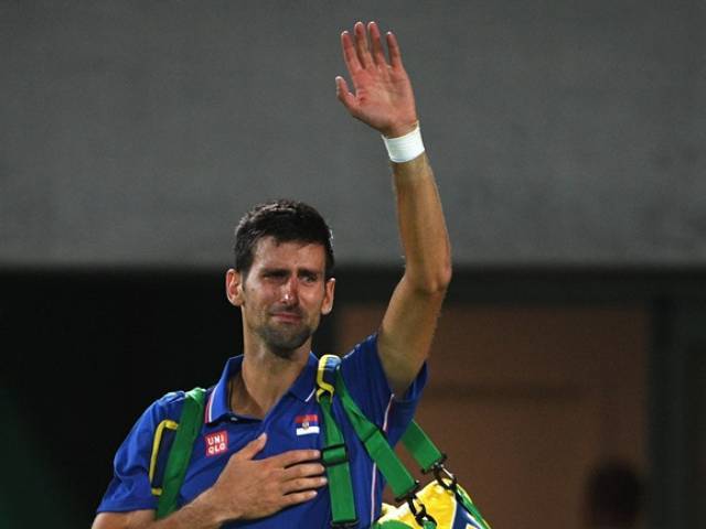 Novak Djokovic waves to the crowd with tears in his eyes after losing to Juan Martin Del Potro at the Olympic Tennis Centre in Rio de Janeiro