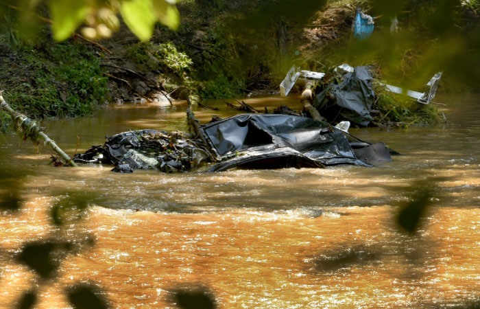 A submerged car is visible in the Patapsco River seen from the Howard County side of Patapsco Valley State Park after the sidewalk caved in due to Saturday night’s flooding in Ellicott City Maryland on Sunday. — AP