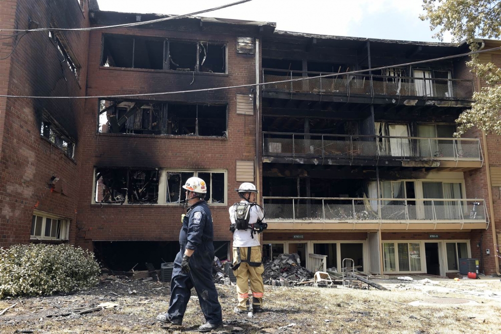 Emergency personnel view the scene of an apartment building fire in Silver Spring Md. Thursday Aug. 11 2016