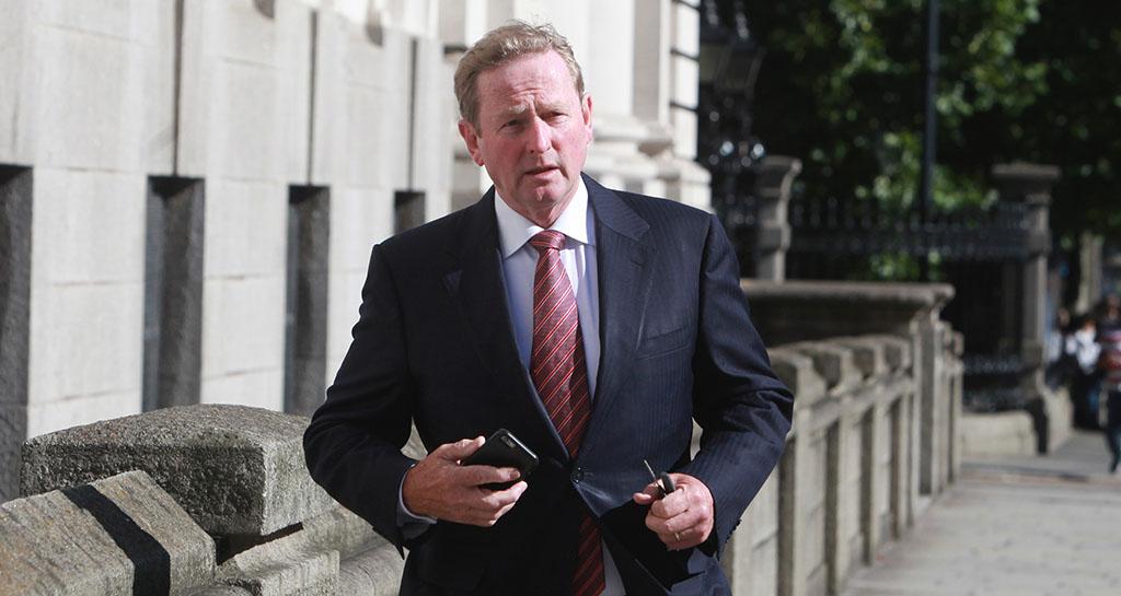 Enda clutches his iPhone as he arrives at Government Buildings Pic