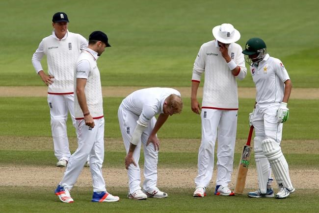 England's Ben Stokes centre holds is leg after a delivery and before going off injured during day four of the second test against Pakistan at Old Trafford Manchester England Monday