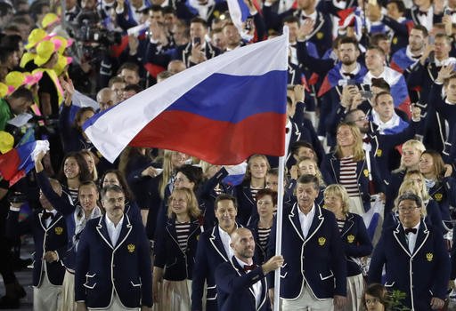 Sergei Tetiukhin carries the flag of Russia during the opening ceremony for the 2016 Summer Olympics in Rio de Janeiro Brazil Friday Aug. 5 2016