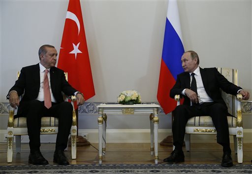 Russian President Vladimir Putin right and Turkish President Recep Tayyip Erdogan talk during their meeting in the Konstantin palace outside