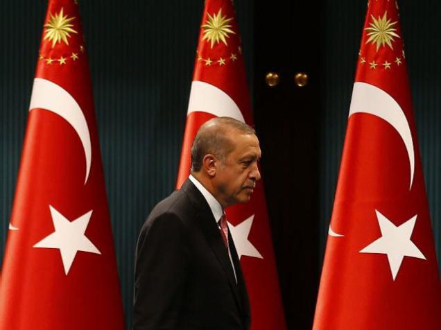 Turkish President Recep Tayyip Erdogan leaves after a news conference following the National Security Council and cabinet meetings at the Presidential Palace in Ankara