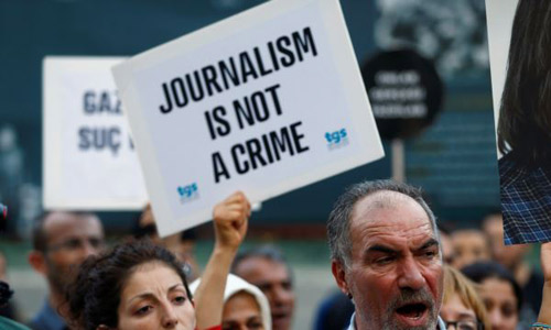 Demonstrators shout slogans during a protest against the arrest of three prominent activists for press freedom in central Istanbul Turkey