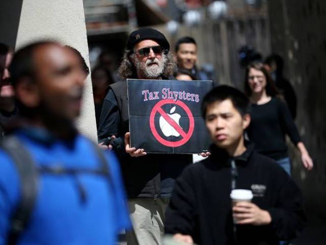 15 2014 shows a protester holding a sign during a demonstration outside of an Apple Store