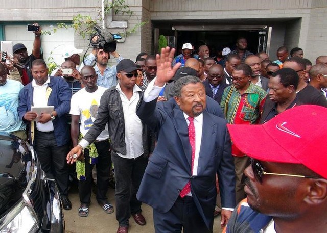 Gabonese opposition candidate Jean Ping greets supporters outside his campaign headquarters after proclaiming that he won the presidential election in Libreville Gabon