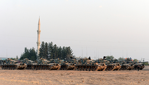 Turkish tanks stationed near the Syrian border in Karkamis Turkey Saturday Aug. 27 2016. Turkey on Wednesday sent tanks across the border to help Syrian rebels retake the key Islamic State-held town of Jarablus and to contain the expansion of Syria's