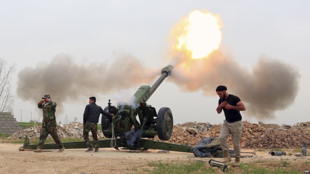 FILE- Iraqi security forces fire at Islamic State militants positions from villages south of the Islamic State group-held city of Mosul Iraq