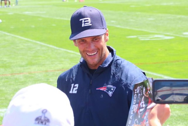 Fans cheered as Tom Brady signed autographs after practice on Saturday