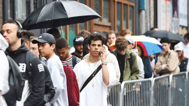 Fans queue in the rain