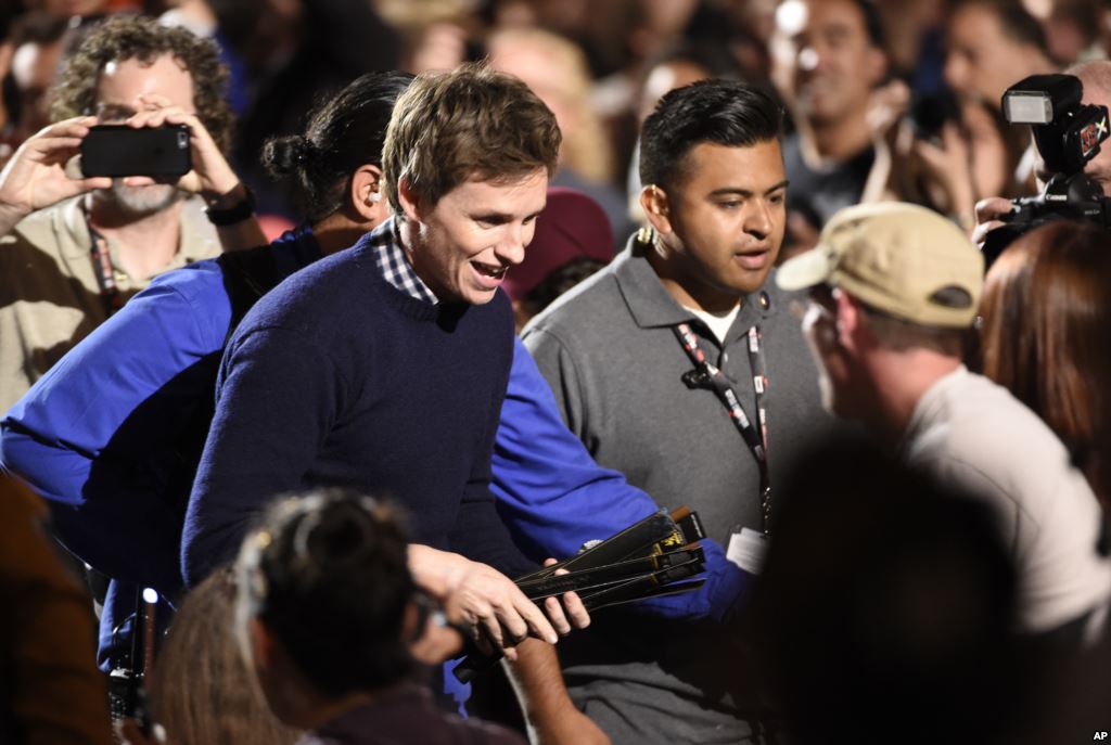 Eddie Redmayne hands out wands to the audience at the'Fantastic Beasts and Where to Find Them panel on Day 3 of Comic Con International in San Diego