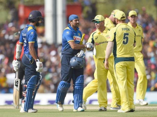 Tillakaratne Dilshan is congratulated by David Warner and teammates as he leaves the ground after being dismissed in Dambulla