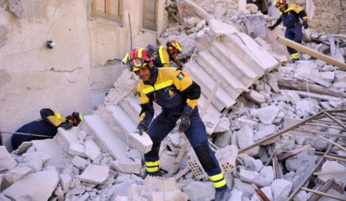 Firefighters at work amid the rubble in Pescara del Tronto