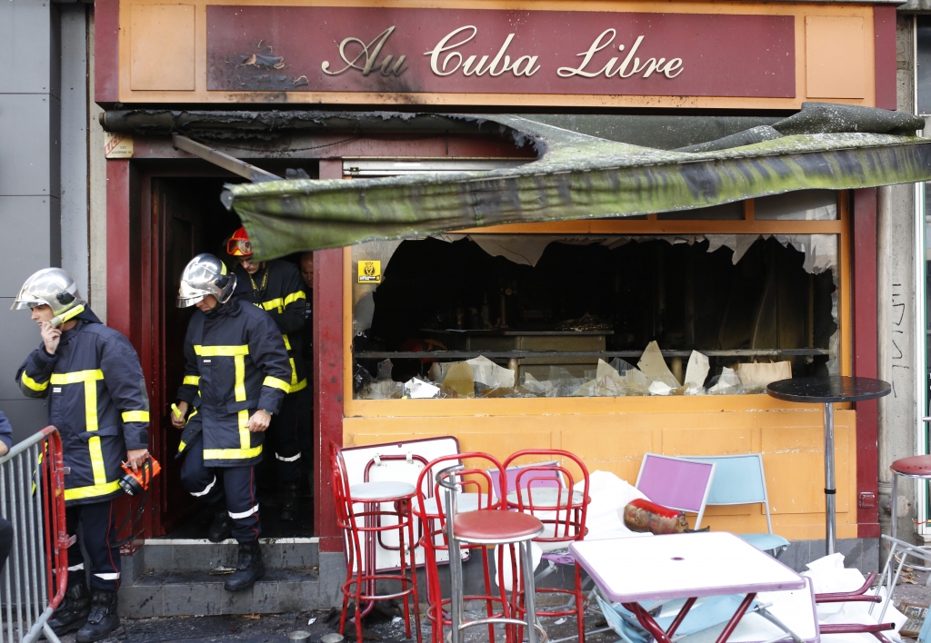 Firefighters leave the bar where a fire broke out Saturday in Rouen France