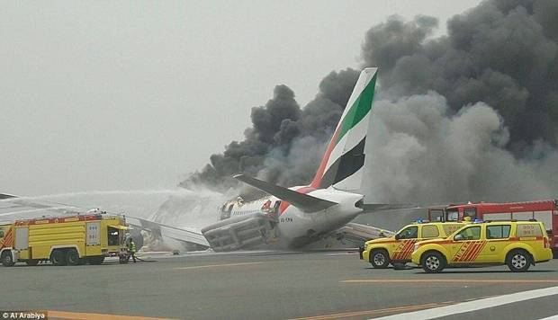 Firefighters tackle the blaze on the aircraft at Dubai Airport