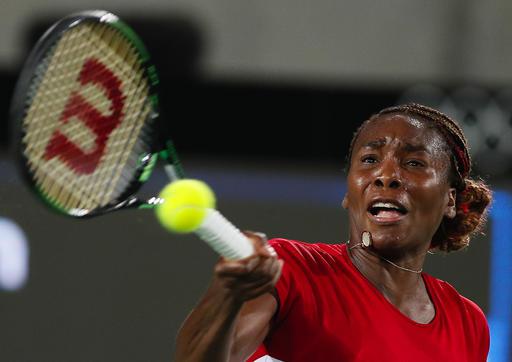 Venus Williams of the United States returns a ball to Belgium's Kirsten Flipkens in the women's tennis competition at the 2016 Summer Olympics in Rio de Janeiro Brazil Saturday Aug. 6 2016