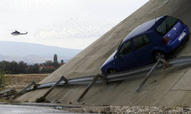 Police in a helicopter search for possible victims flying over a flooded area after a storm near the village of Stajkovci just east of Skopje Macedonia on Monday Aug. 8 2016. Macedonia is mourning Monday the victims of a deadly storm that hit Satur