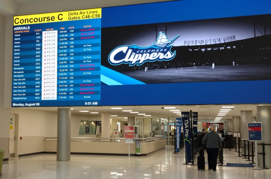 Flight departures are displayed in front of a TSA security checkpoint for Delta flights