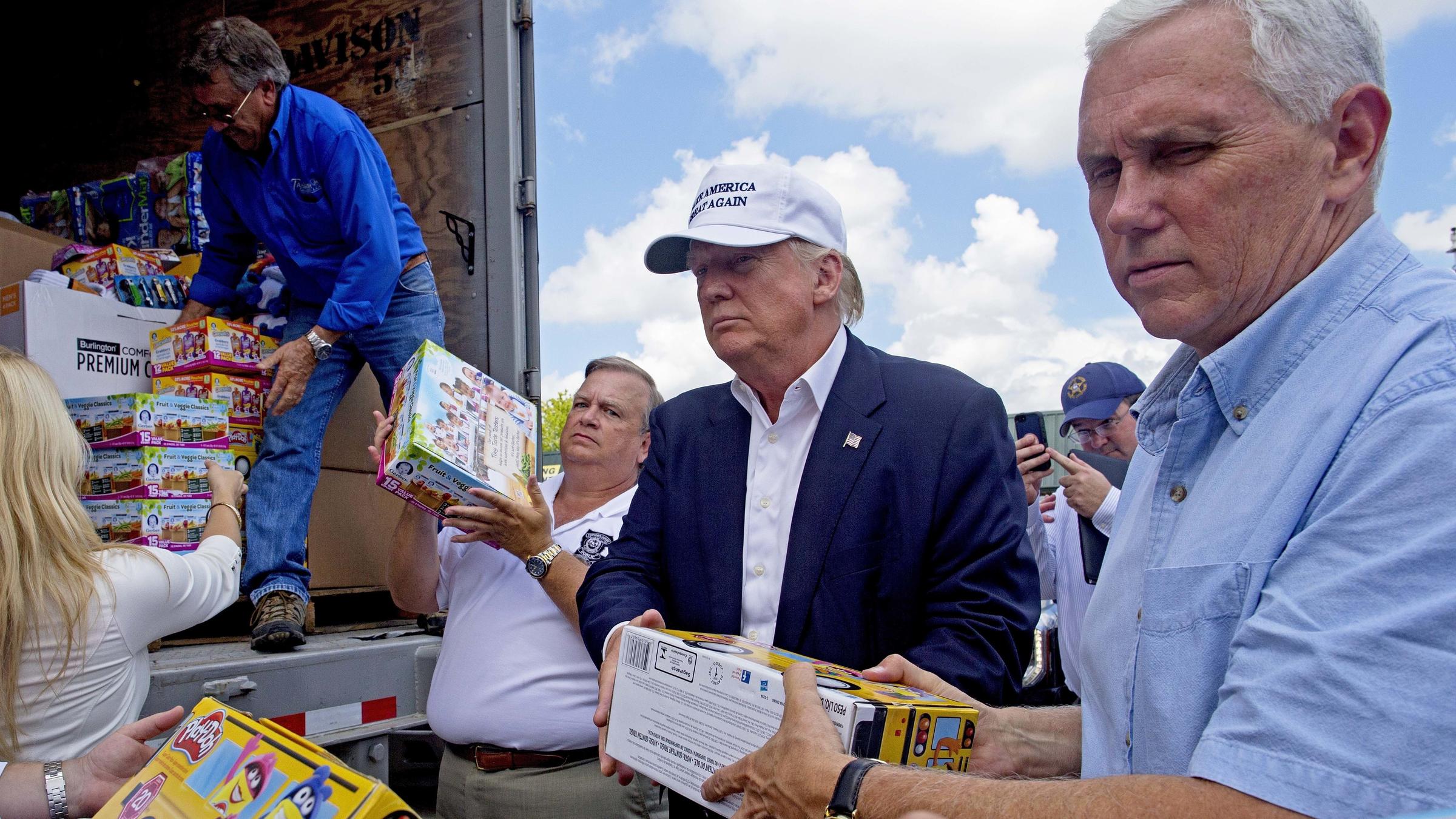 Republican presidential candidate Donald Trump holds a Hispanic advisory roundtable meeting in New York Saturday Aug. 20 2016. At right is Jovita Carranza former Small Business Administration Deputy Administrator