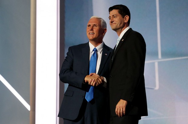 Speaker of the House Paul Ryan shakes the hand of Republican Vice Presidential candidate Mike Pence as he walks on stage to deliver a speech at the Republican National Convention