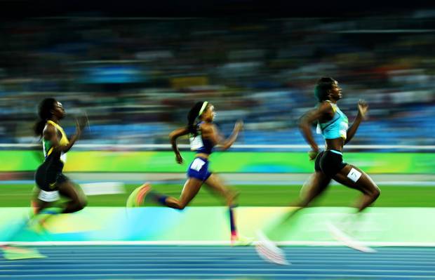 Miller right runs ahead Allyson Felix middle