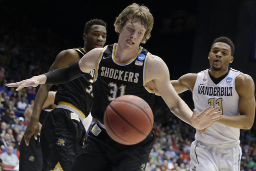 FILE- Wichita State's Ron Baker eyes a loose ball as Vanderbilt's Jeff Roberson follows during the first half of a First Four game of the NCAA men's college basketball tournament Tuesday