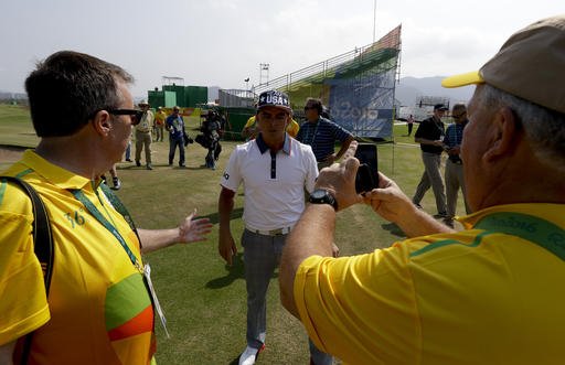 Volunteers greets Rickie Fowler of the United States after a practice round for men's golf event at the 2016 Summer Olympics in Rio de Janeiro Brazil Tuesday Aug. 9 2016