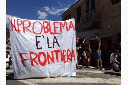 A No Borders group of activists shows a banner reading