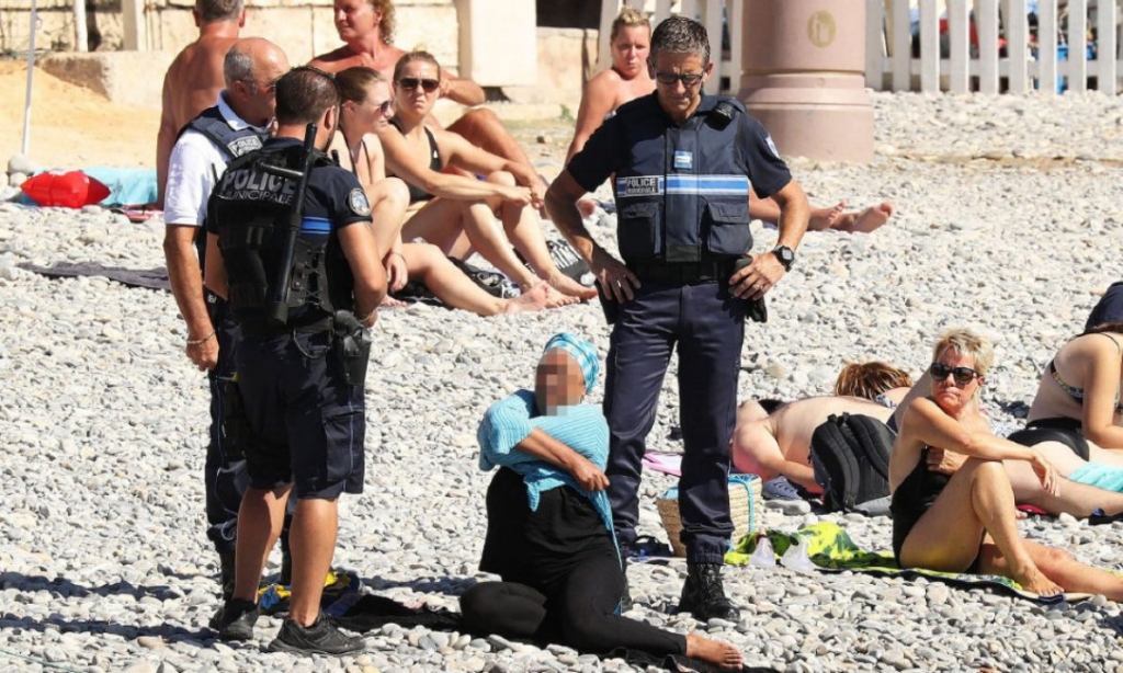 Police fined the woman for wearing a burkini and asked her to remove her covering in front of fellow beachgoers