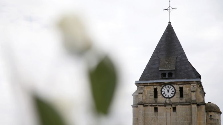 A white rose is attached to a post in front of the church a day after a hostage-taking in Saint-Etienne-du-Rouvray near Rouen in Normandy France where French priest Father Jacques Hamel was killed with a knife and another hostage seriously wounded. Th