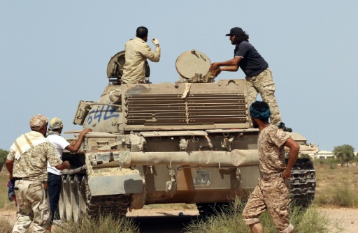 AFP  File  Mahmud Turkia
Fighters from the pro-government forces loyal to Libya's Government of National Unity are seen around a tank