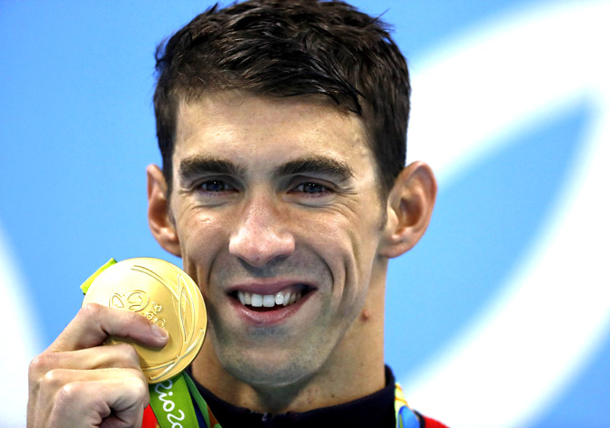 USA's Michael Phelps poses on the podium with his gold medal after he won the Men's 200m Butterfly Final during the swimming event at the Rio 2016 Olympic Games at the Olympic Aquatics Stadium in Rio de Janeiro. Pic  AFP