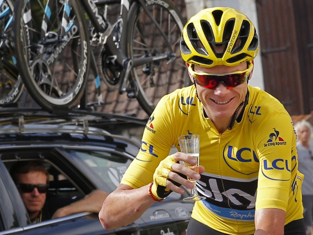 Britain's Chris Froome wearing the overall leader's yellow jersey celebrates with a glass of champagne during the twenty-first stage of the Tour de France cycling race over 113 kilometers with start in Chantilly and finish in Pari