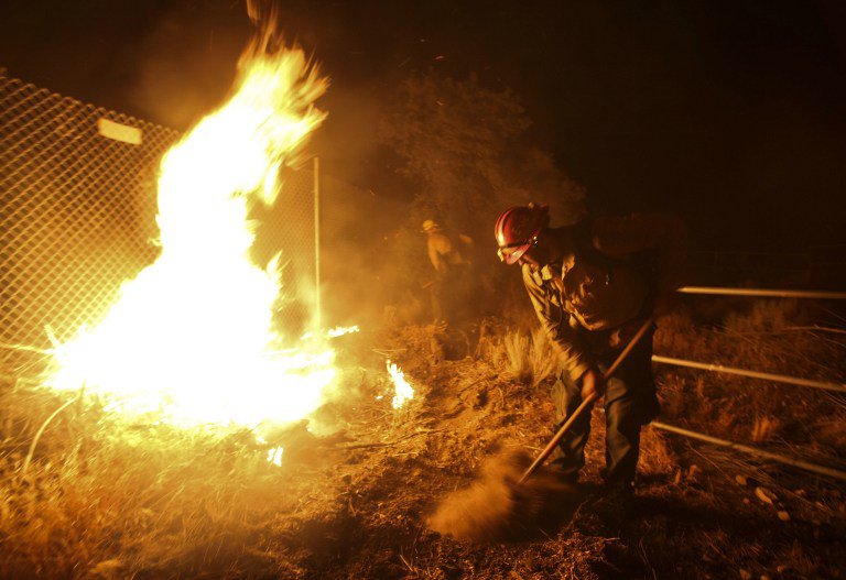 A rapidly spreading fire raging east of Los Angeles forced the evacuation of more than 82,000 people on August 16 as the governor