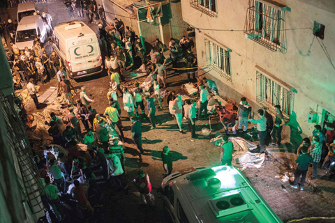 GAZIANTEP Turkey Ambulances arrive at the site of an explosion on Saturday following a late night militant attack on a wedding party.- AFP