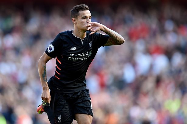 Philippe Coutinho of Liverpool celebrates after scoring the equalising goal