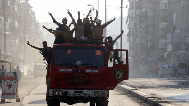 Rescue workers celebrate in Aleppo 6 August