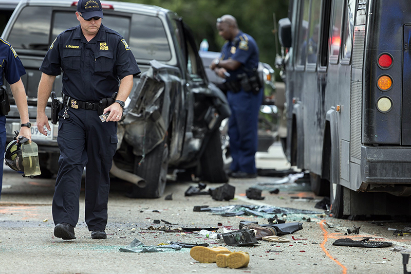 Police investigate the scene of a fatal wreck involving a bus and several cars on Interstate 10 near Laplace La. Sunday Aug. 28 2016