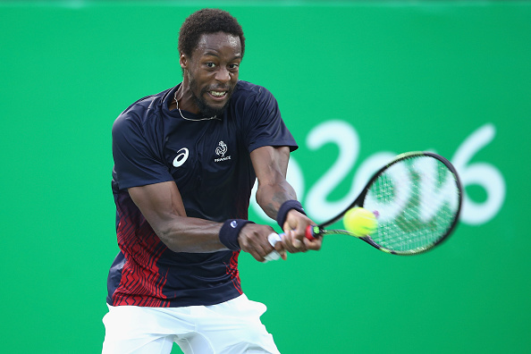 Gael Monfils plays a backhand shot to Kei Nishikori