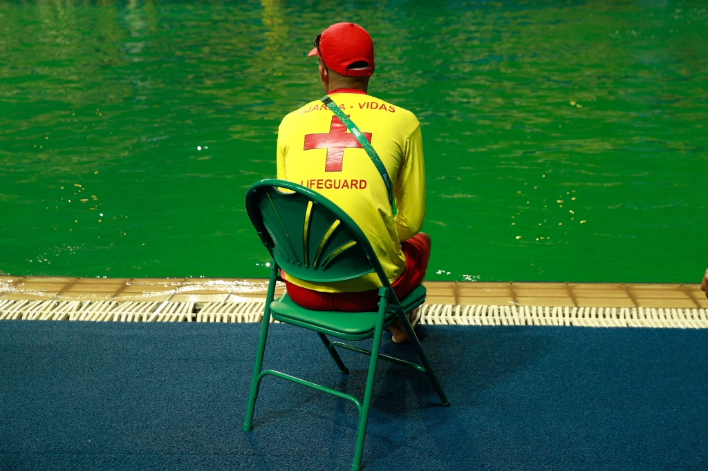 A lifeguard sits by the edge of the diving pool at Maria Lenk Aquatics Centre on Day 4 of the Rio 2016 Olympic Games at Maria Lenk Aquatics Centre