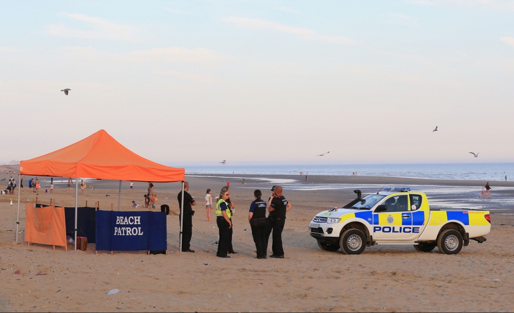 Police officers on Camber Sands near Rye East Sussex