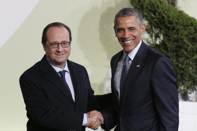 French President Francois Hollande left greets U.S. President Barack Obama as he arrives for the COP21 United Nations Climate Change Conference in Le Bourget outside Paris Monday Nov. 30 2015