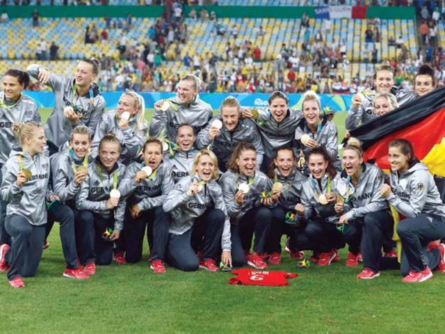 Germany’s players pose with their first ever gold medals after their team’s victory over Sweden during the Rio 2016 Olympic Games