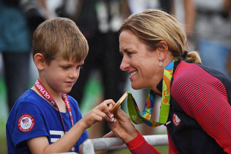 American Kristin Armstrong shows her gold medal to son Lucas 5 after winning the cycling time trial