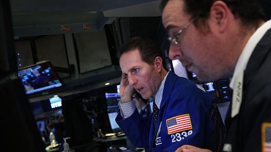 Traders work on the floor of the New York Stock Exchange