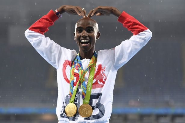 Gold medallist Britain's Mo Farah celebrates near the podium for the Men's 5000m