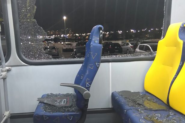 The damages to the window of a Olympic journalists bus hit while driving